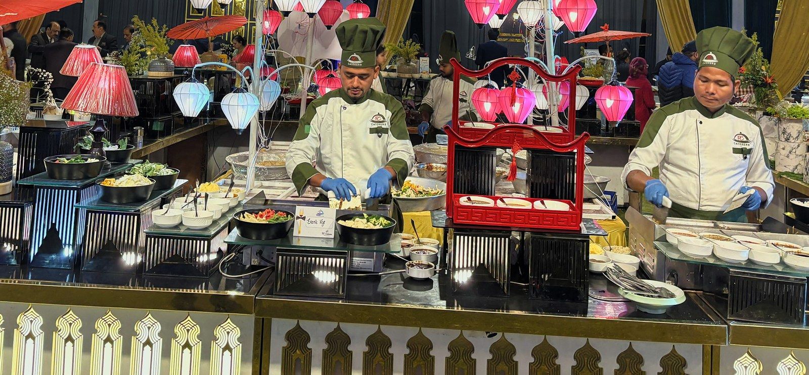 Chefs at a Japanese live station under paper lanterns